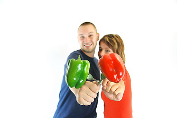 Image showing happy couple with peppers isolated