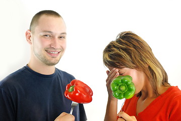 Image showing happy couple with peppers isolated