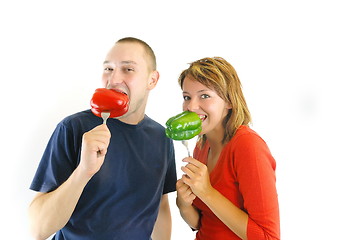 Image showing happy couple with peppers isolated