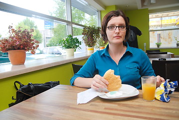 Image showing woman eating at an restaurant