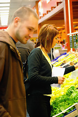 Image showing happy couple buying fruits in hypermarket