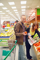 Image showing happy couple buying fruits in hypermarket