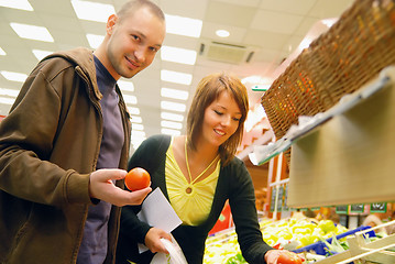 Image showing happy couple buying fruits in hypermarket