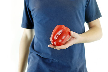 Image showing happy couple holding peppers with head