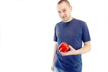 Image showing happy couple holding peppers with head