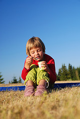 Image showing happy girl eating healthy food in nature