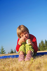 Image showing happy girl eating healthy food in nature