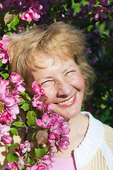 Image showing a middle-aged woman in a blossoming magnolias