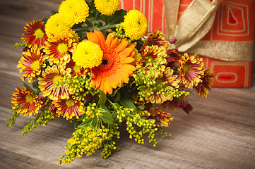 Image showing  giftbox and a bouquet of flowers 