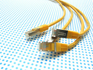 Image showing yellow ethernet cable on dotted background