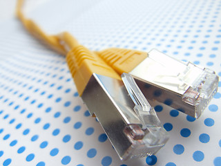 Image showing yellow ethernet cable on dotted background