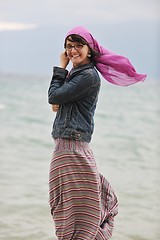 Image showing beautiful young woman on beach with scarf