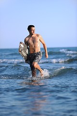 Image showing Portrait of a young  kitsurf  man at beach on sunset