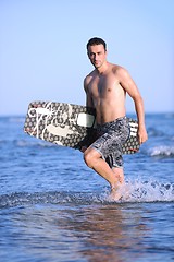 Image showing Portrait of a young  kitsurf  man at beach on sunset