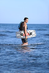 Image showing Portrait of a young  kitsurf  man at beach on sunset