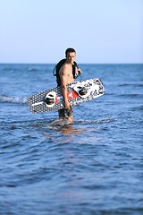 Image showing Portrait of a young  kitsurf  man at beach on sunset