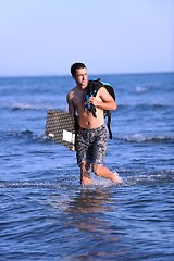 Image showing Portrait of a young  kitsurf  man at beach on sunset