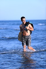 Image showing Portrait of a young  kitsurf  man at beach on sunset