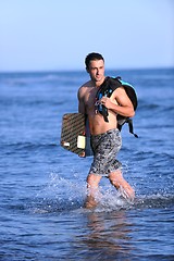 Image showing Portrait of a young  kitsurf  man at beach on sunset