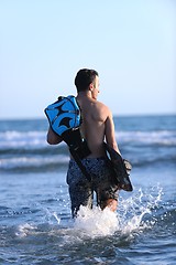 Image showing Portrait of a young  kitsurf  man at beach on sunset