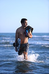 Image showing Portrait of a young  kitsurf  man at beach on sunset