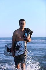 Image showing Portrait of a young  kitsurf  man at beach on sunset