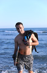 Image showing Portrait of a young  kitsurf  man at beach on sunset