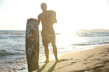 Image showing Portrait of a young  kitsurf  man at beach on sunset