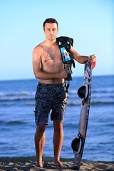 Image showing Portrait of a young  kitsurf  man at beach on sunset