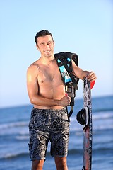 Image showing Portrait of a young  kitsurf  man at beach on sunset