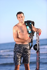 Image showing Portrait of a young  kitsurf  man at beach on sunset