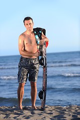 Image showing Portrait of a young  kitsurf  man at beach on sunset