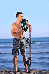 Image showing Portrait of a young  kitsurf  man at beach on sunset