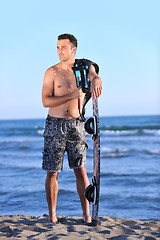 Image showing Portrait of a young  kitsurf  man at beach on sunset