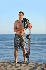 Image showing Portrait of a young  kitsurf  man at beach on sunset