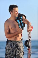 Image showing Portrait of a young  kitsurf  man at beach on sunset