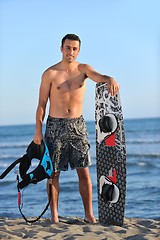 Image showing Portrait of a young  kitsurf  man at beach on sunset