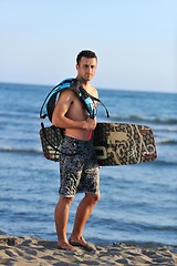 Image showing Portrait of a young  kitsurf  man at beach on sunset