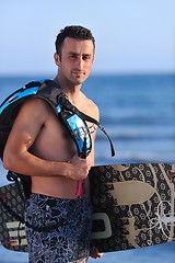 Image showing Portrait of a young  kitsurf  man at beach on sunset