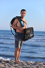 Image showing Portrait of a young  kitsurf  man at beach on sunset