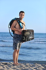 Image showing Portrait of a young  kitsurf  man at beach on sunset