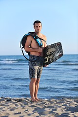 Image showing Portrait of a young  kitsurf  man at beach on sunset