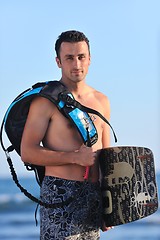 Image showing Portrait of a young  kitsurf  man at beach on sunset