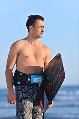 Image showing Portrait of a young  kitsurf  man at beach on sunset