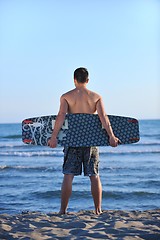 Image showing Portrait of a young  kitsurf  man at beach on sunset