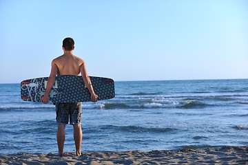 Image showing Portrait of a young  kitsurf  man at beach on sunset