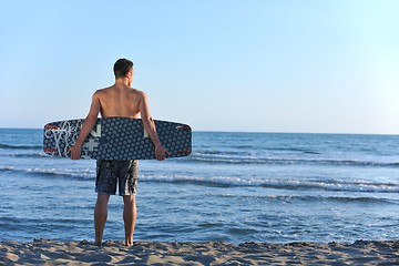 Image showing Portrait of a young  kitsurf  man at beach on sunset