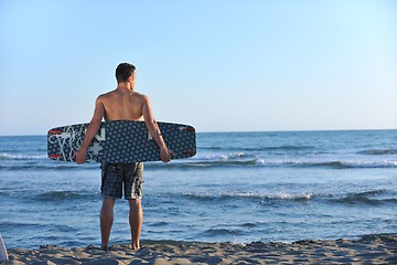 Image showing Portrait of a young  kitsurf  man at beach on sunset