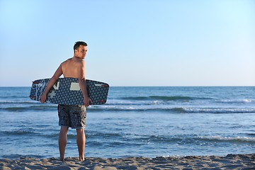 Image showing Portrait of a young  kitsurf  man at beach on sunset