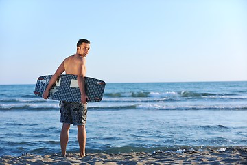 Image showing Portrait of a young  kitsurf  man at beach on sunset